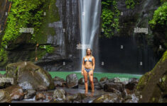 A Young Woman In Swimming Suit Is Posing At Hidden Waterfall Near for Hidden Pictures Swimming Jpg